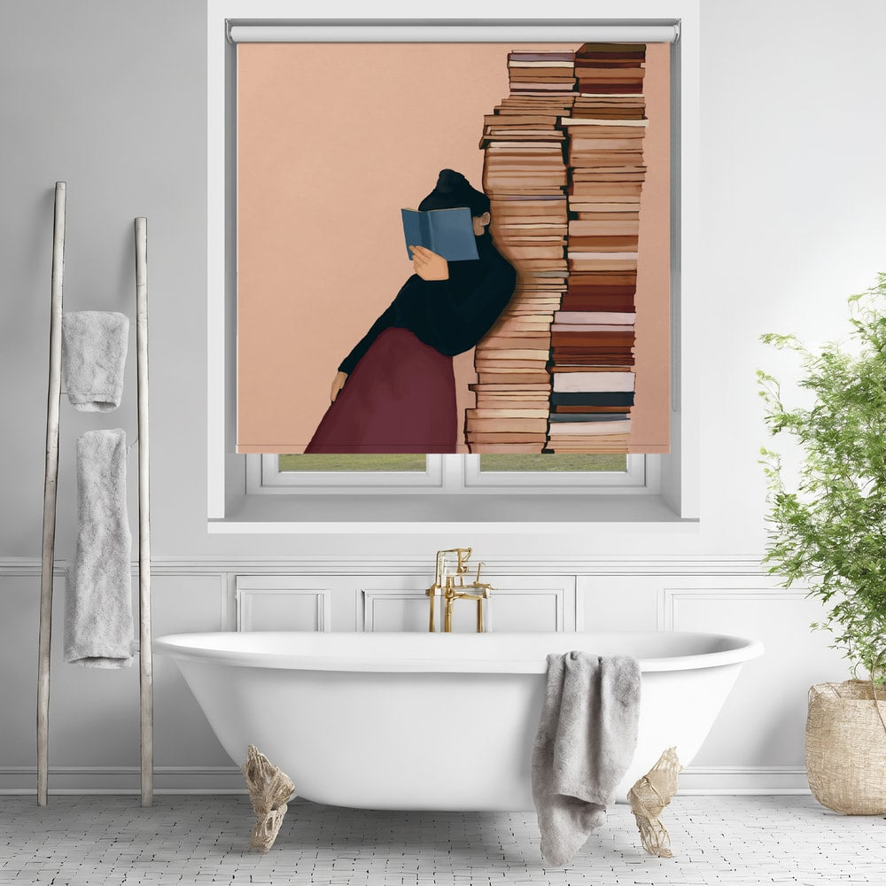 Printed roller blind featuring a graphic illustration of a person reading a blue book while leaning against a very tall stack of books on a peach background