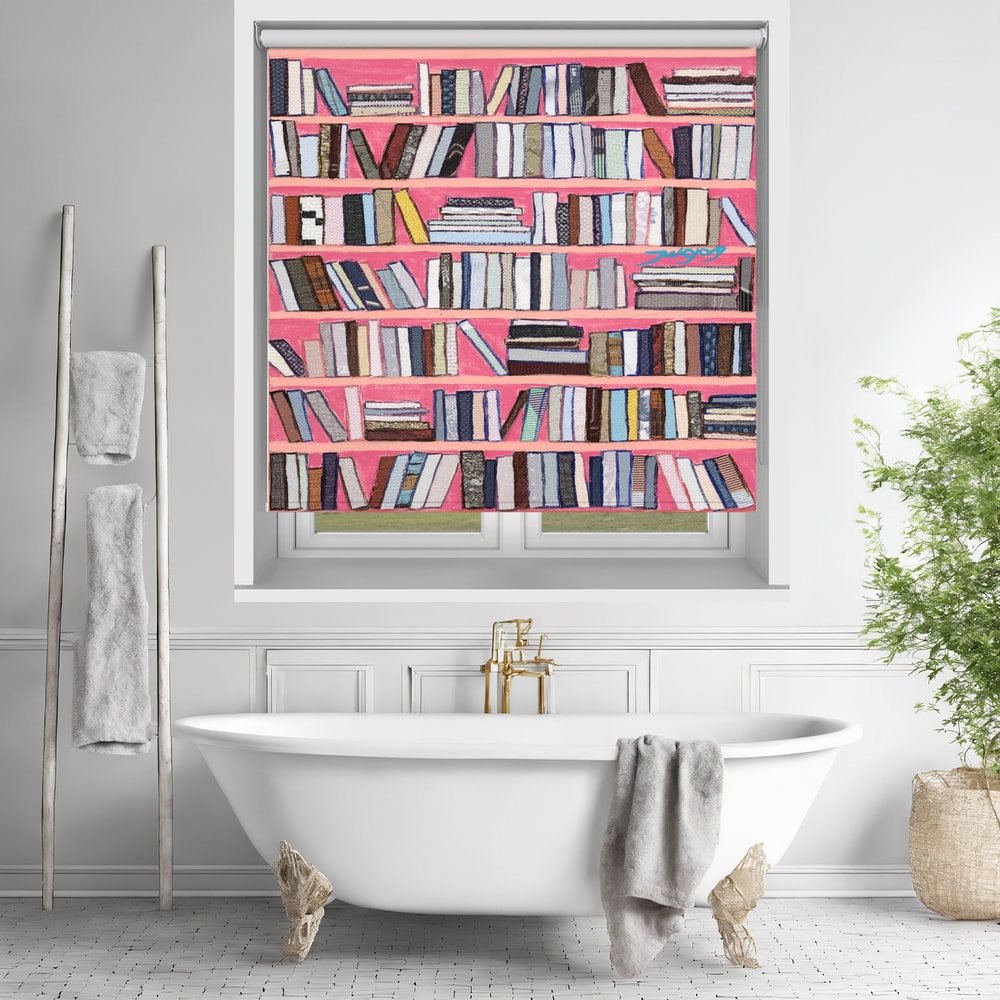 Printed roller blind featuring a vibrant faux bookshelf with colourful books on bright pink shelves, hanging over a white freestanding bathtub