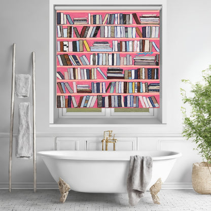 Printed roller blind featuring a vibrant faux bookshelf with colourful books on bright pink shelves, hanging over a white freestanding bathtub