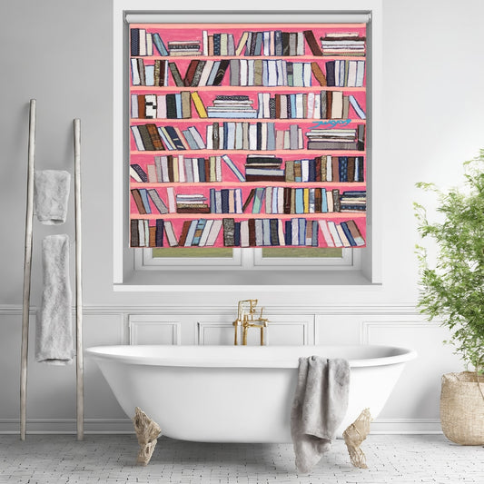 Printed roller blind featuring a vibrant faux bookshelf with colourful books on bright pink shelves, hanging over a white freestanding bathtub