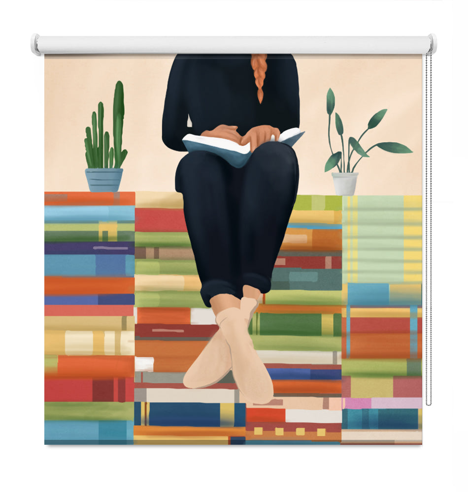 A decorative window roller shade featuring a colorful illustration of a person sitting on stacks of books and reading, with two potted plants, shown against a plain white background.