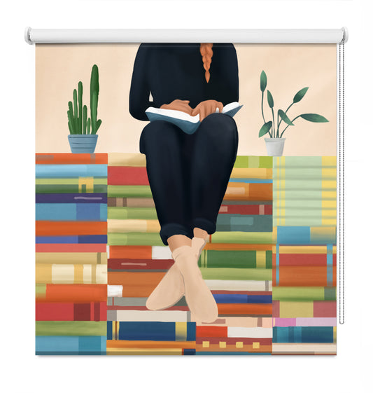 A decorative window roller shade featuring a colorful illustration of a person sitting on stacks of books and reading, with two potted plants, shown against a plain white background.