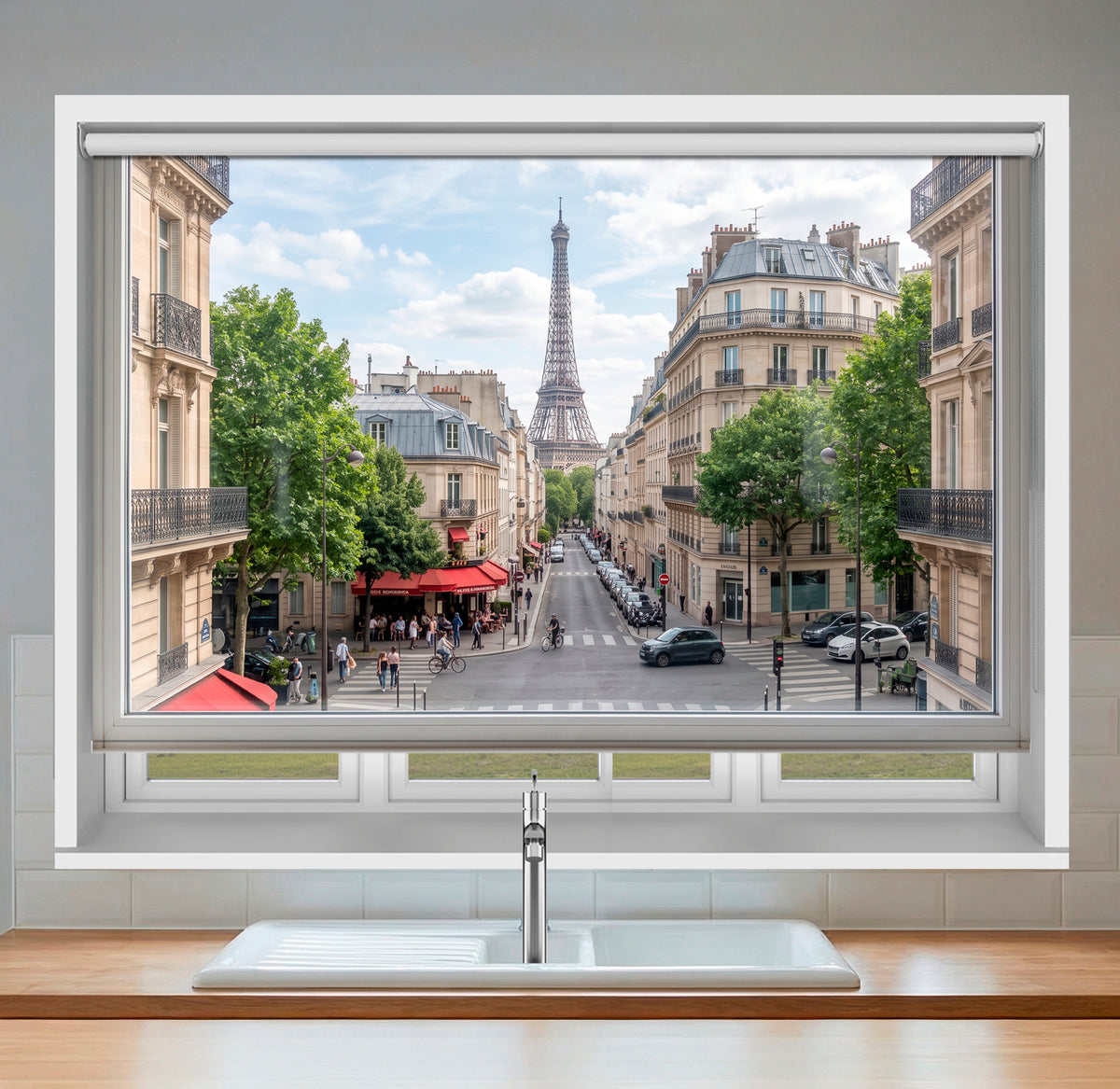 Art Fever faux window roller blind featuring a daytime Parisian street scene and the Eiffel Tower, installed over a modern white kitchen sink.