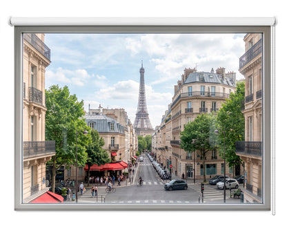 Close-up of an Art Fever scenic roller blind showing a realistic daytime view of a bustling Paris street and the Eiffel Tower inside a faux white window frame.