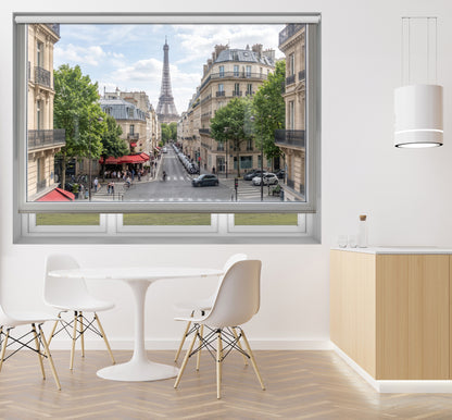 Art Fever Paris cityscape faux window roller blind styled in a bright, modern dining area with a minimalist white table and chairs.