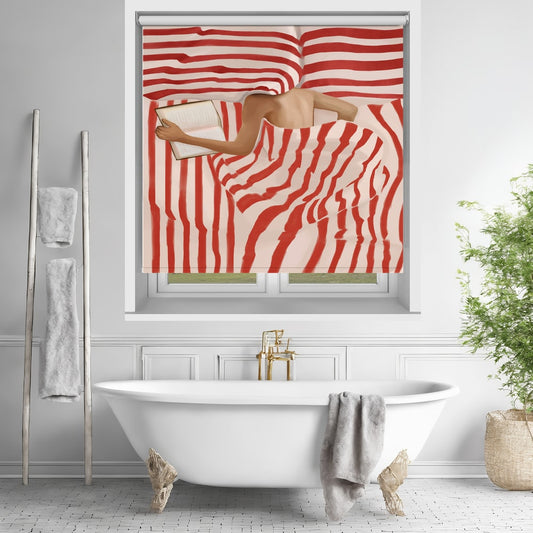 Printed roller blind featuring a painted illustration of a person reading a book while lying in bed under bold red and white striped bedding