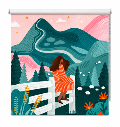 Printed roller blind featuring a whimsical illustration of a girl in an orange striped dress sitting on a white fence, with sheep, pine trees, and teal mountains in the background under a pink sky