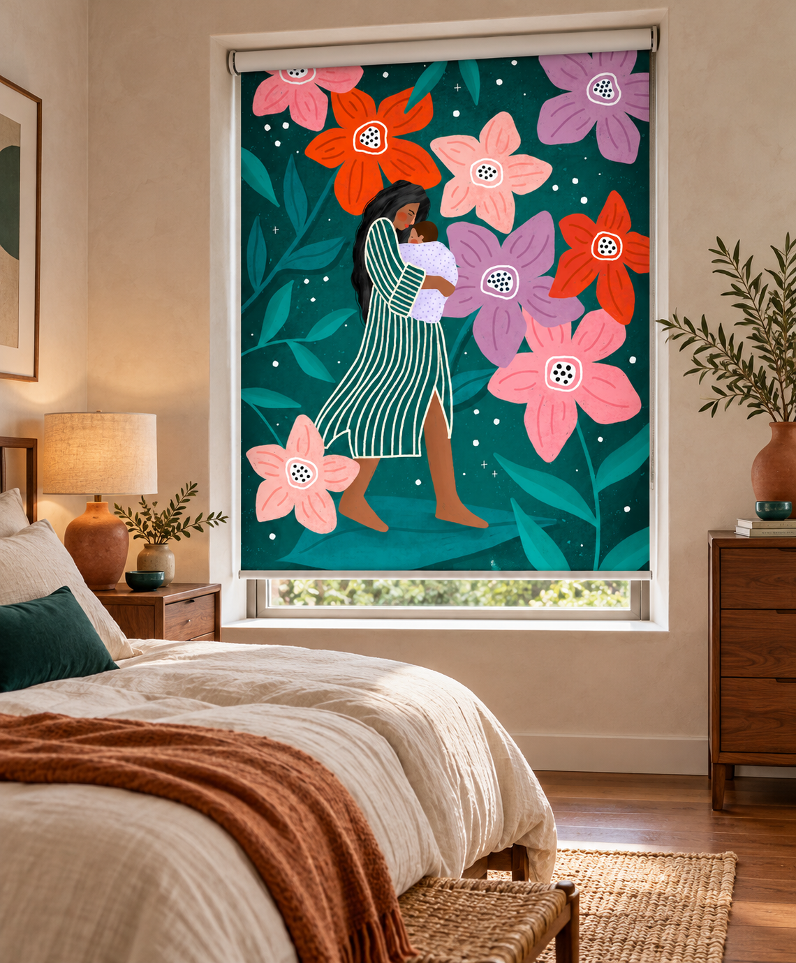A roller shade window blind with a colorful graphic print of a woman in a green striped dress surrounded by large pink, orange, and purple flowers, shown hanging in a styled bedroom.