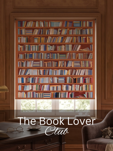 A book-themed roller blind featuring a printed pattern of book spines, shown hanging in a cozy, wood-paneled room with a desk, chair, and cat. The text 'The Book Lover Club' is overlaid at the bottom.