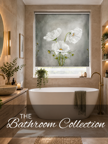 A modern bathroom scene featuring a gray roller blind with a white floral print above a freestanding bathtub. The room has warm beige walls, a vessel sink, and brass fixtures, with the text 'THE Bathroom Collection' overlaid at the bottom.