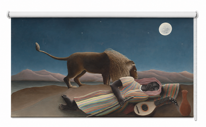 A decorative wall roller shade featuring a surreal painting of a lion standing over a sleeping man under a full moon, shown against a plain white background.