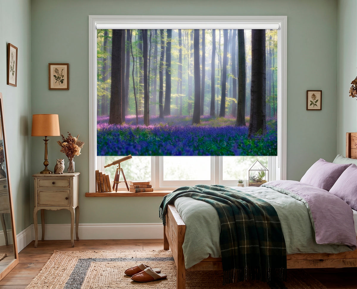 Bedroom with a large window showing a forest view, featuring a bed with green and purple bedding.